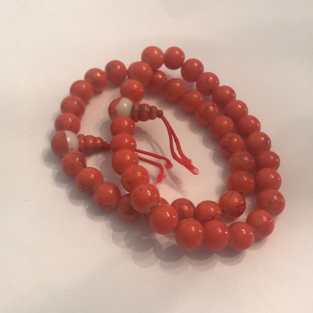Two orange layered beaded bracelets